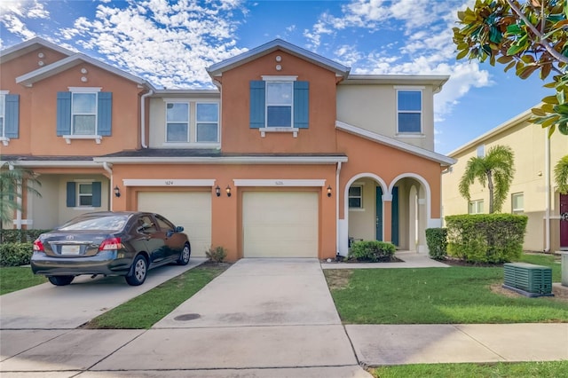 view of front of home featuring a garage and cooling unit