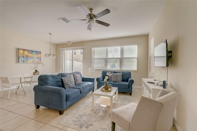 tiled living room with ceiling fan