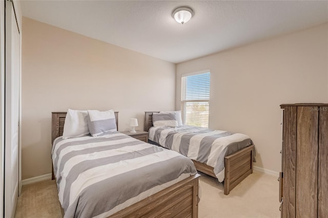 bedroom featuring light carpet