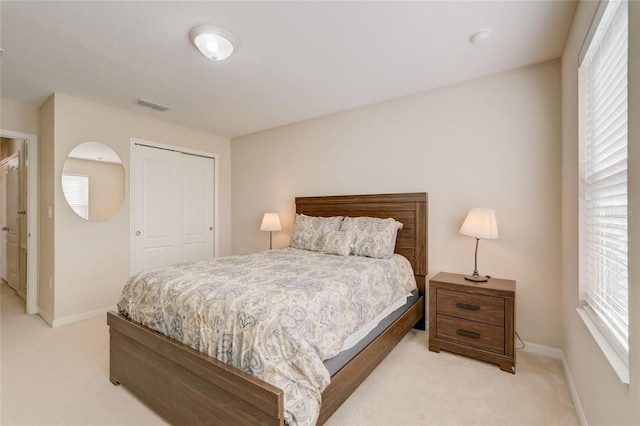 carpeted bedroom with a closet