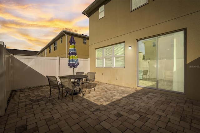 view of patio terrace at dusk