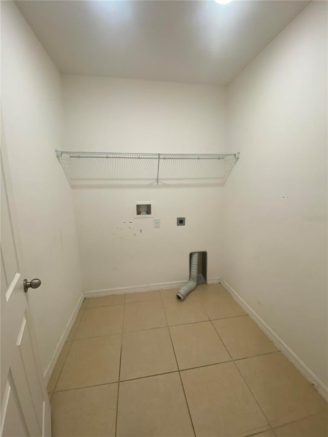 laundry area with hookup for a washing machine, light tile patterned floors, and electric dryer hookup