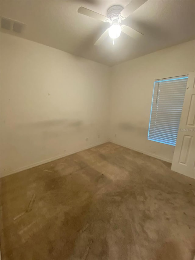 spare room featuring carpet floors and ceiling fan