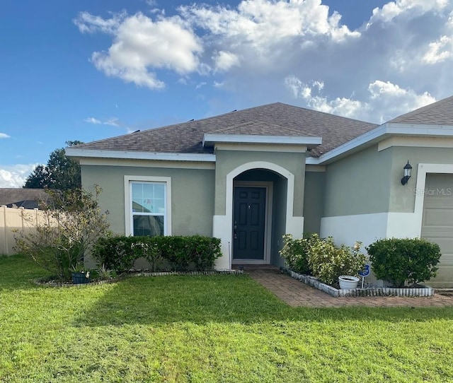 view of front of property with a front lawn and a garage