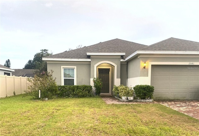 view of front of house with a front yard and a garage