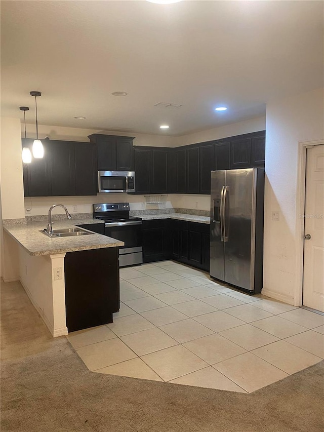 kitchen featuring sink, kitchen peninsula, stainless steel appliances, pendant lighting, and light colored carpet