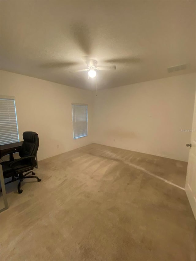 home office with carpet flooring and ceiling fan