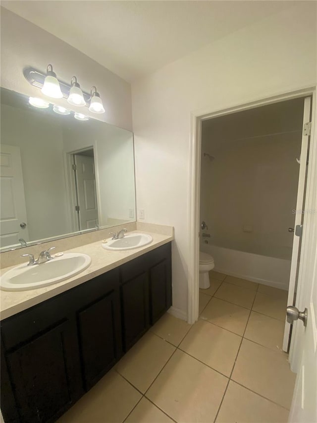 full bathroom featuring toilet, shower / washtub combination, vanity, and tile patterned flooring