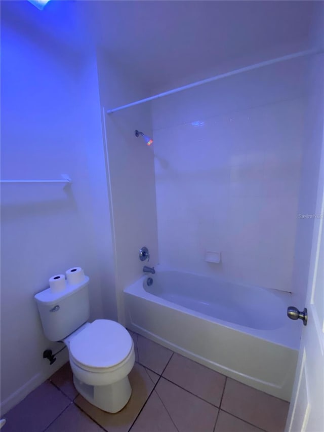 bathroom with toilet, tile patterned floors, and tub / shower combination