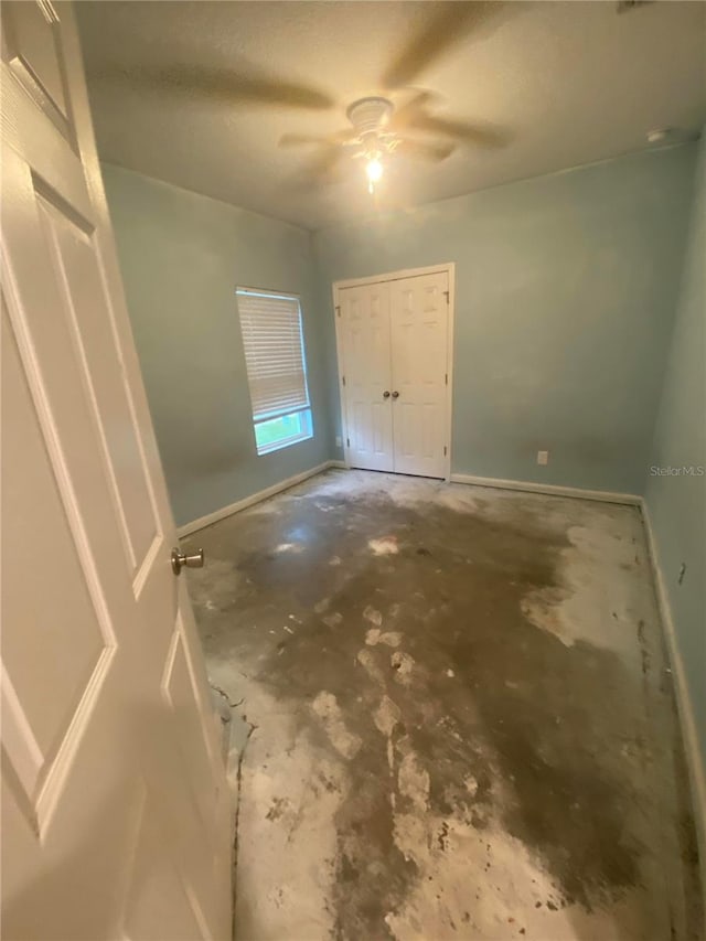 interior space featuring concrete flooring and ceiling fan