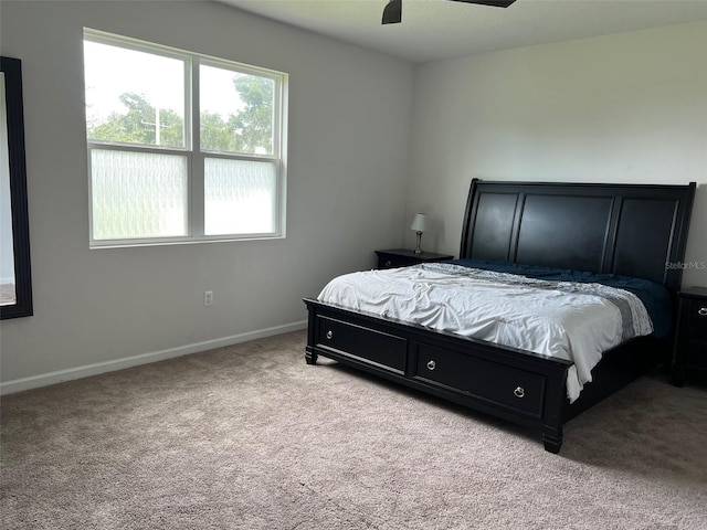 bedroom with light carpet and ceiling fan