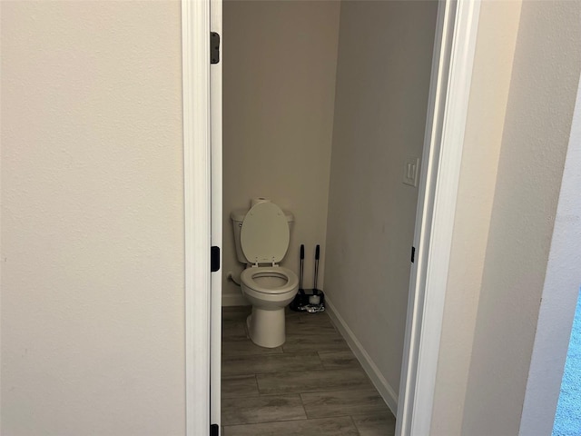 bathroom with wood-type flooring and toilet