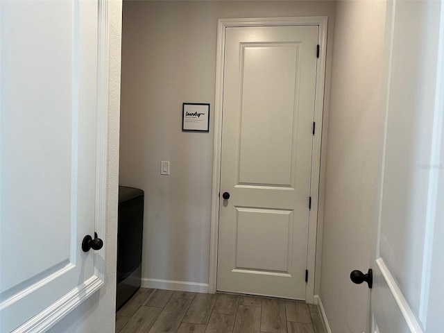 clothes washing area featuring light hardwood / wood-style flooring