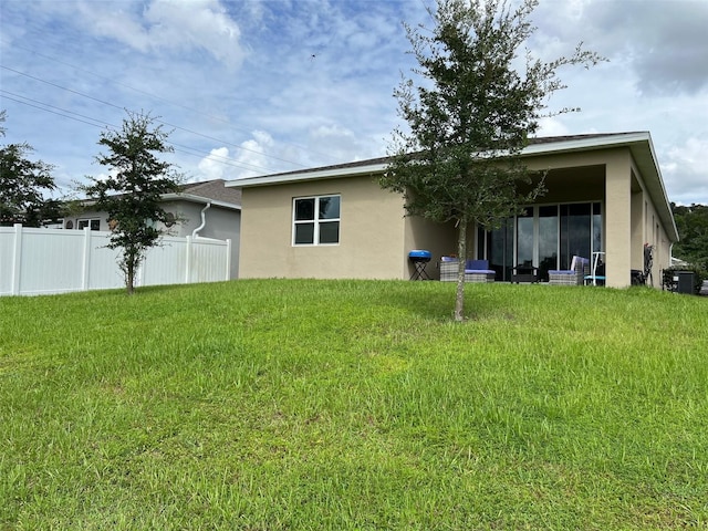 back of house with a yard