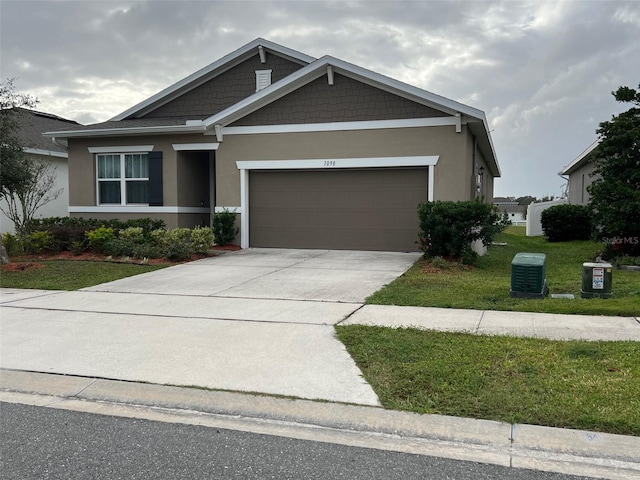 view of front of house featuring a garage and a front lawn