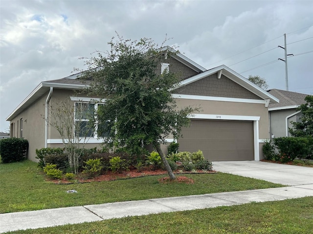 view of front of house featuring stucco siding, driveway, an attached garage, and a front lawn