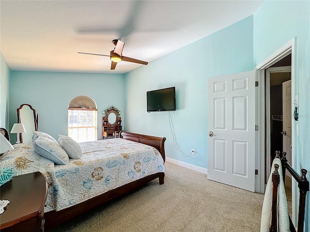 carpeted bedroom with vaulted ceiling and ceiling fan