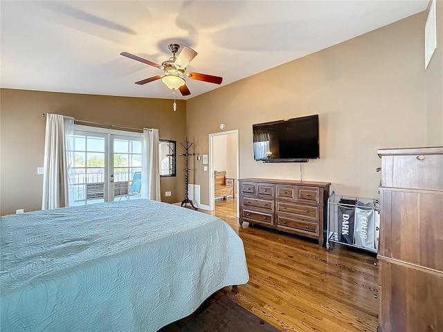 bedroom with wood-type flooring, lofted ceiling, access to exterior, and ceiling fan