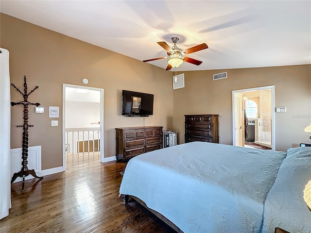 bedroom with dark hardwood / wood-style floors, vaulted ceiling, ensuite bath, and ceiling fan