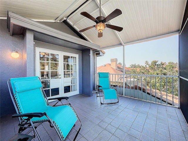 view of patio / terrace with a balcony, ceiling fan, and french doors