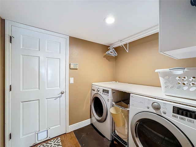 washroom with wood-type flooring and washing machine and dryer