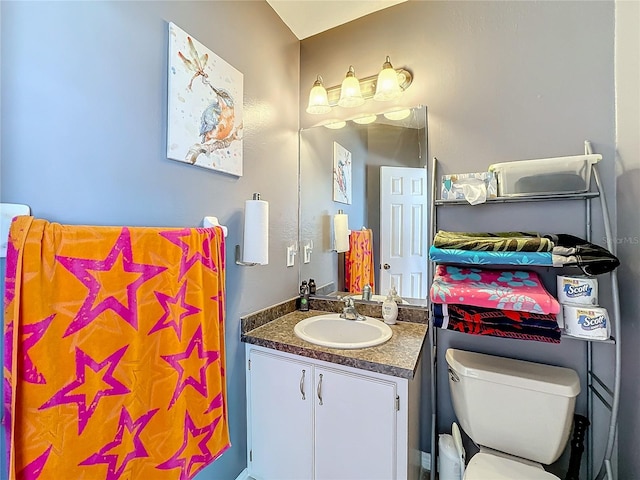 bathroom featuring vanity and toilet