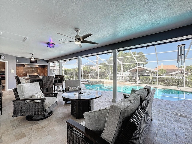 view of patio featuring a lanai and ceiling fan