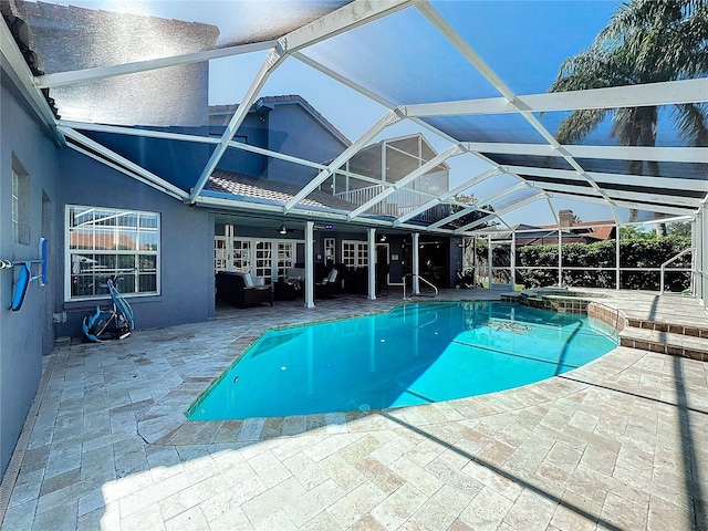 view of swimming pool featuring ceiling fan, a patio, an in ground hot tub, and a lanai