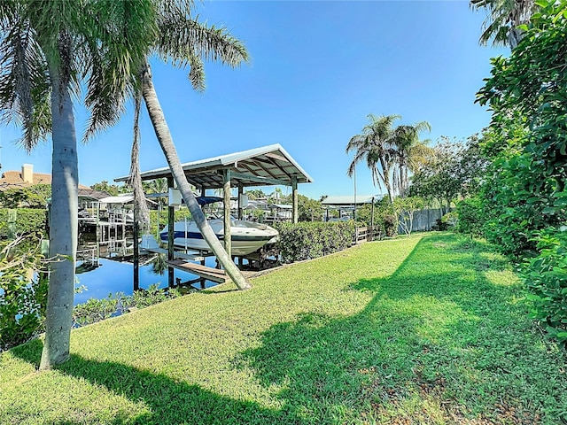 dock area featuring a lawn and a water view