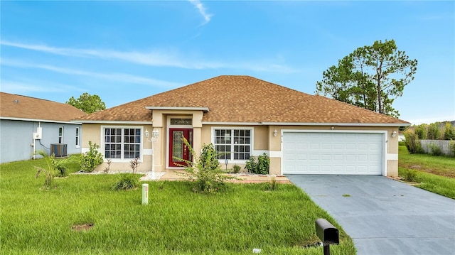 ranch-style house with a garage, a front yard, and central AC