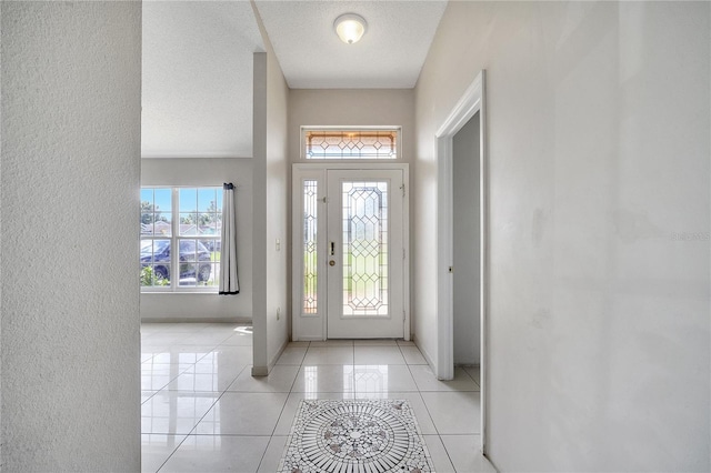 tiled entryway with a textured ceiling