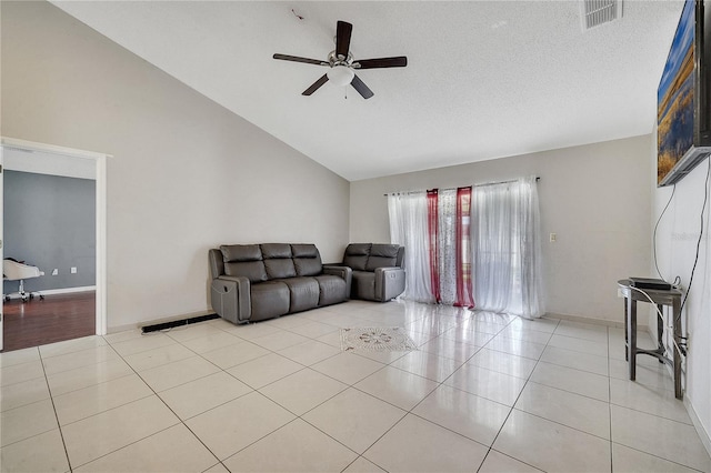 living room featuring a textured ceiling, high vaulted ceiling, light tile patterned floors, and ceiling fan