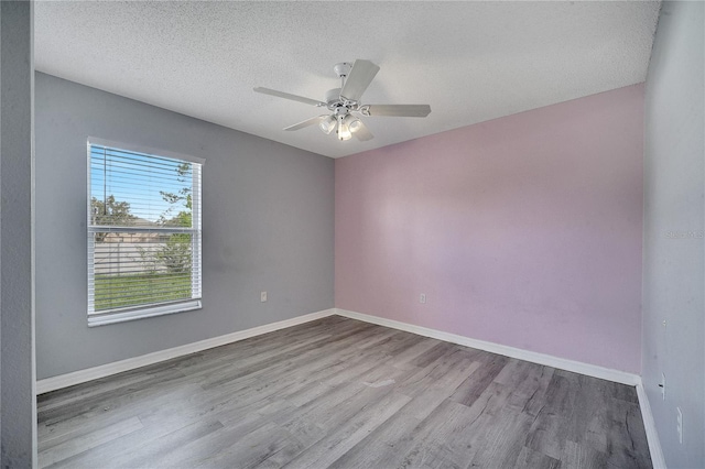 unfurnished room featuring a textured ceiling, hardwood / wood-style floors, and ceiling fan