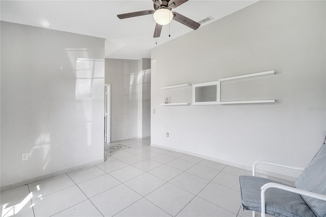 interior space with ceiling fan and light tile patterned flooring