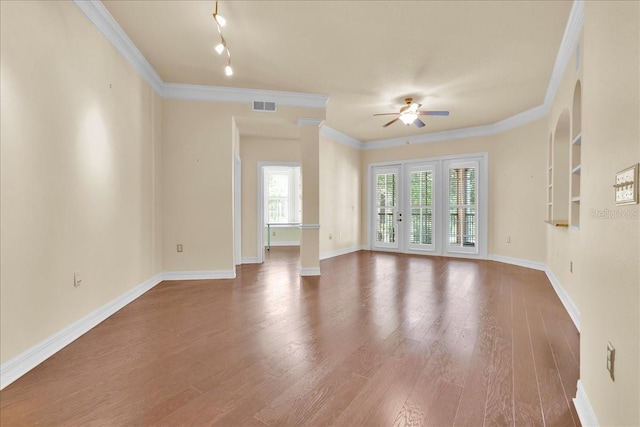 unfurnished living room featuring ceiling fan, ornamental molding, hardwood / wood-style floors, and decorative columns