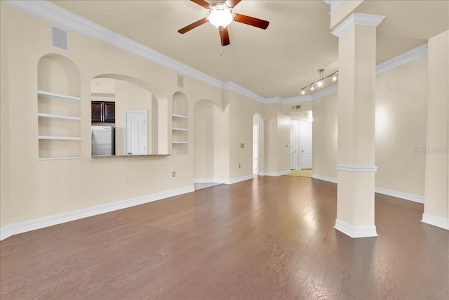 unfurnished room featuring dark hardwood / wood-style flooring, ornate columns, built in features, crown molding, and ceiling fan