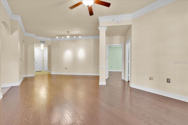 empty room with ceiling fan, hardwood / wood-style flooring, and ornamental molding