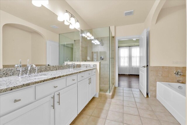 bathroom featuring tile patterned floors, separate shower and tub, and vanity