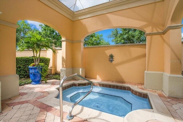 view of pool featuring an in ground hot tub and a patio