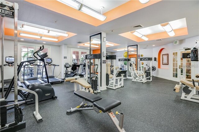 workout area with a raised ceiling