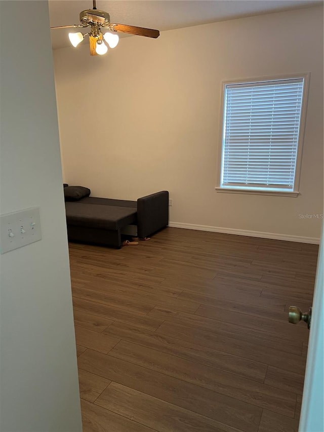 interior space featuring ceiling fan and dark hardwood / wood-style flooring