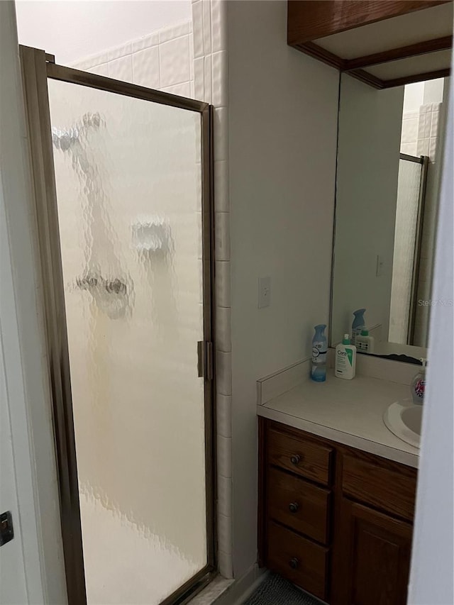 bathroom with an enclosed shower and vanity