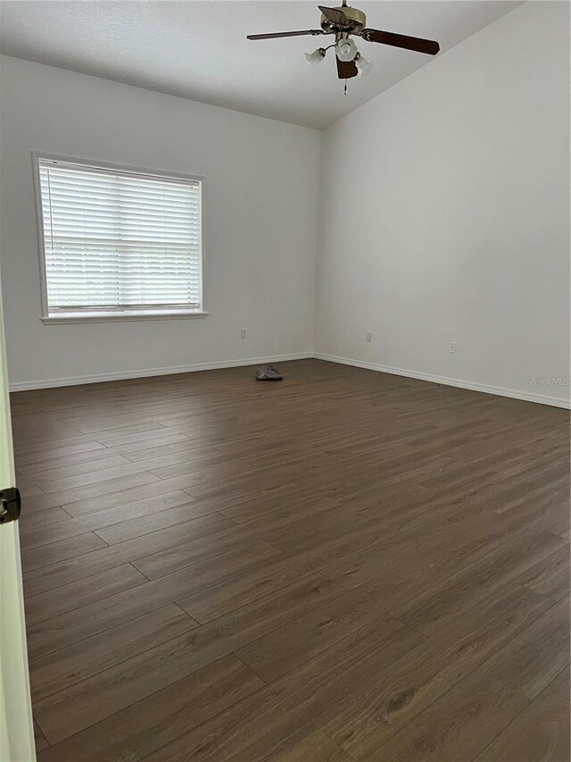 unfurnished room featuring ceiling fan and dark hardwood / wood-style floors