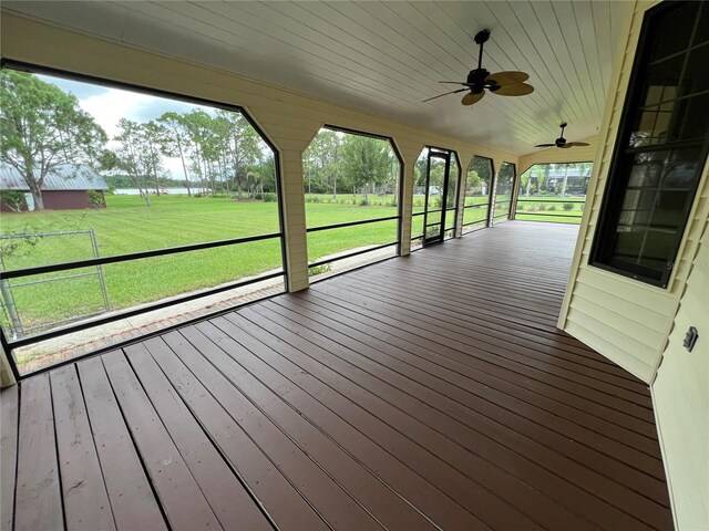 deck with a yard and ceiling fan