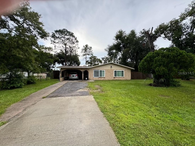 ranch-style home featuring a front yard and a carport