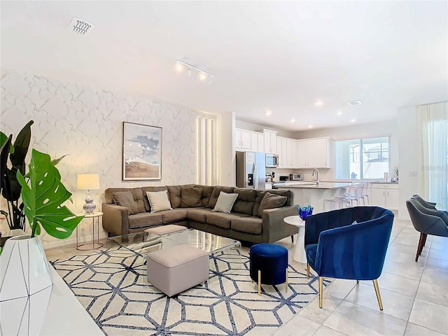 living room featuring track lighting and light tile patterned floors