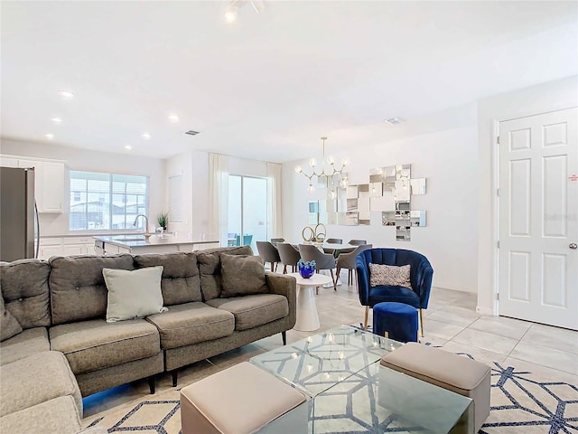 tiled living room featuring an inviting chandelier