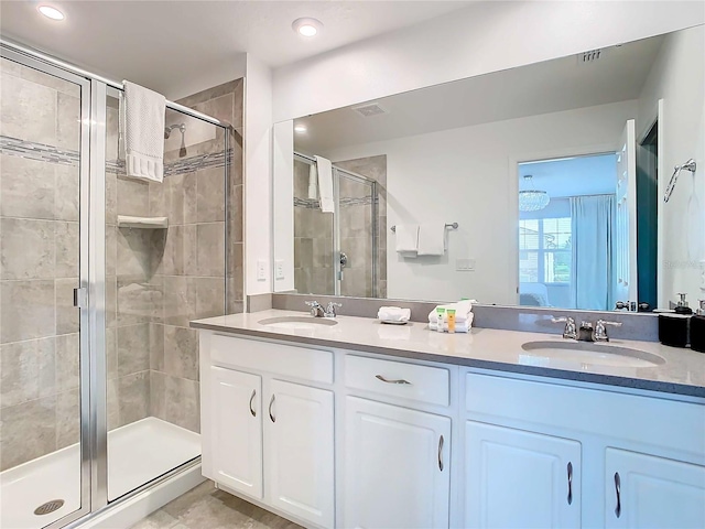 bathroom with a shower with door and vanity