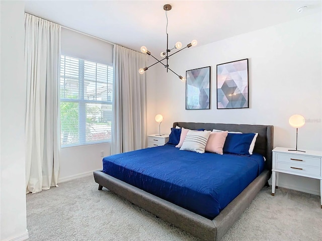 bedroom featuring light carpet and a chandelier