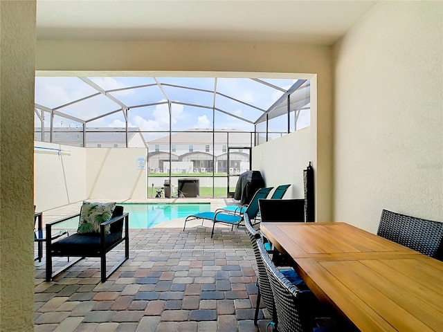 view of patio / terrace featuring glass enclosure